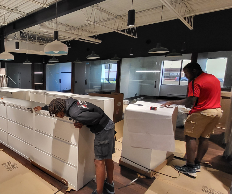 the assembly experts team assembling office furniture for a commercial client.