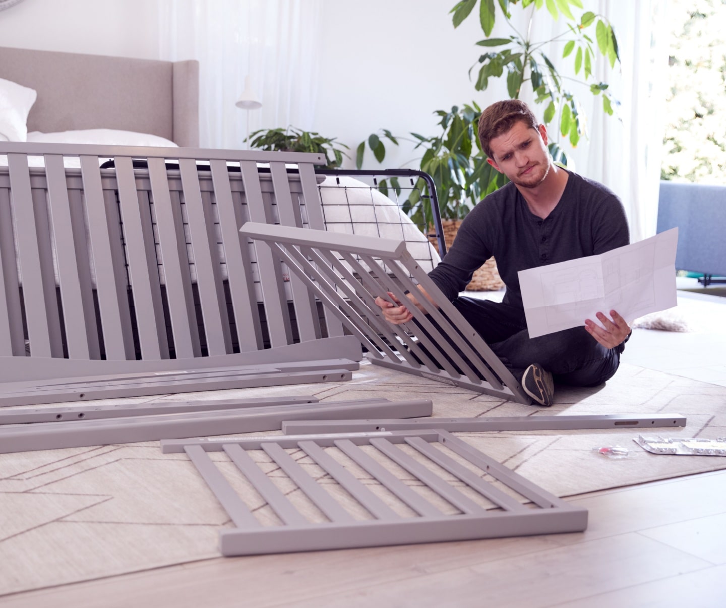 Confused Father To Be Looking At Instructions For Self Assembly