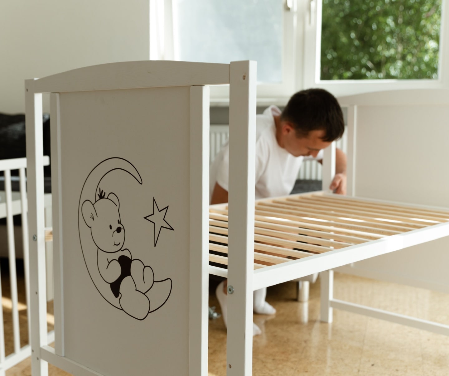 worker installing a crib