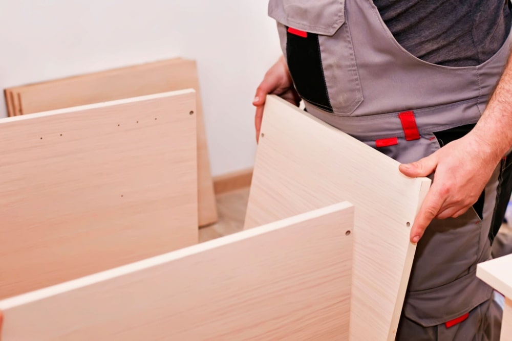 Handyman in the process of assembling a cabinet